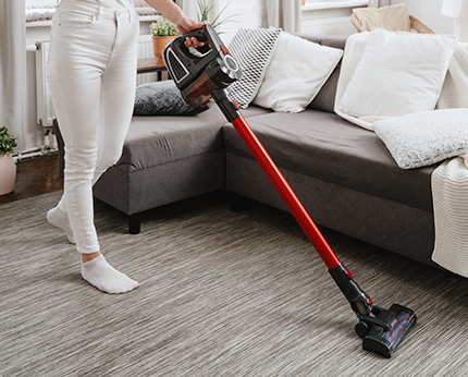 Lady Using Handheld Vacuum Cleaner