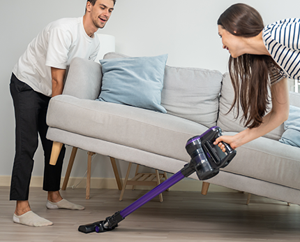 Couple Cleaning with Handheld Vacuum